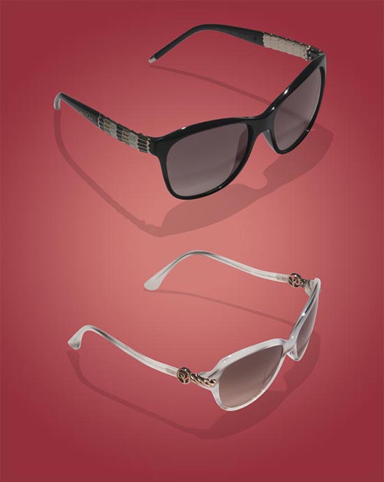 Two pairs of sunglasses, one black and one white, displayed on a red background.