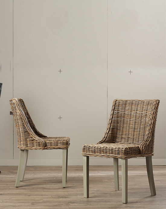 Background removal services for two wicker chairs with gray legs against a neutral background in a minimalistic room.