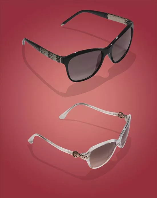 Two pairs of sunglasses, one black and one white, displayed on a red background.