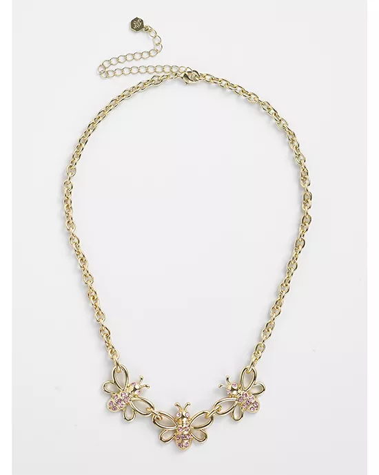 Gold necklace with a butterfly centerpiece and pink gemstones, set against a striped background.