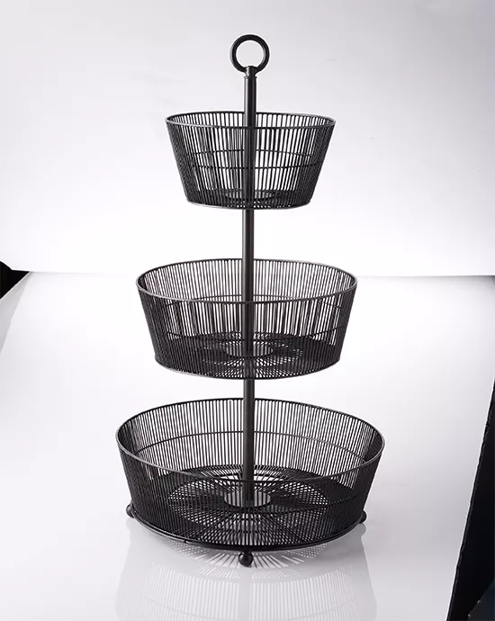 Clipping Path service for a three-tiered black wire fruit basket stand on a reflective white surface.