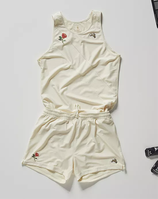 Cream-colored tank top and shorts set with embroidered rose and bird designs on a flat surface.