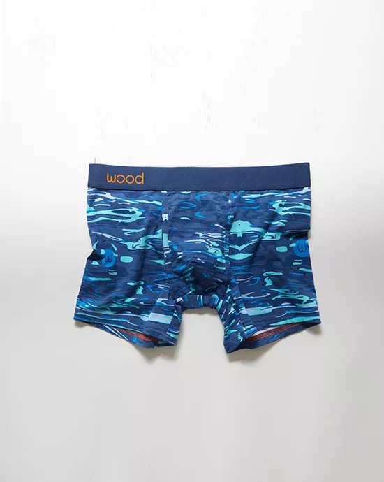 5_Befre Close-up of blue-patterned elastic waistband with orange "wood" label on a softly blurred background.