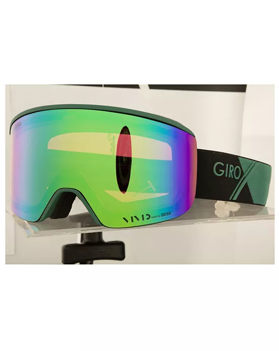 Colorful ski goggle with reflective green lens on display stand featuring "GIRO" logo.