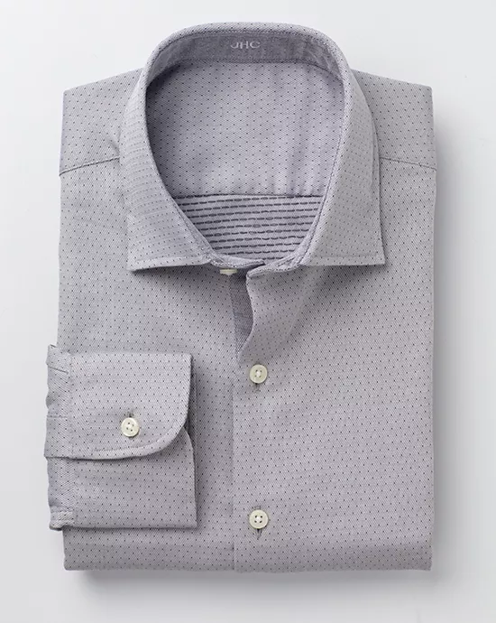 Folded light gray dress shirt with subtle diamond pattern, classic collar, and buttoned cuff.