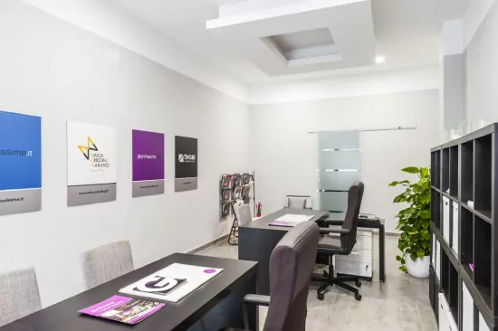 4_before Modern office with two desks, plant, and branded wall art, shown for Sky Replacement Services.