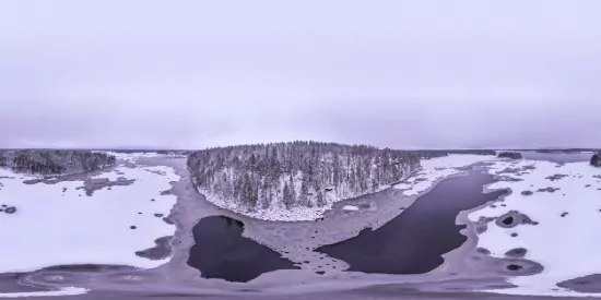 Serene winter landscape with snowy island surrounded by frozen rivers and soft overcast sky.
