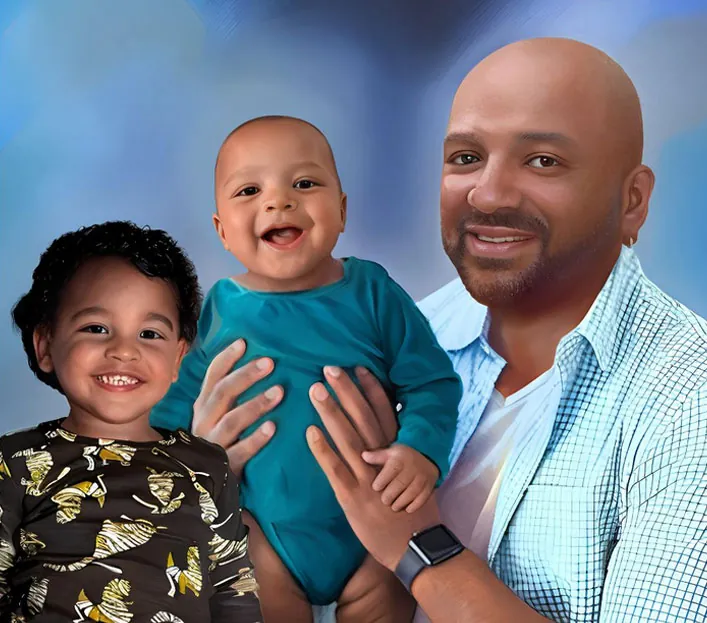 Photo resizing services for a smiling man holding two young children against a blue gradient background.