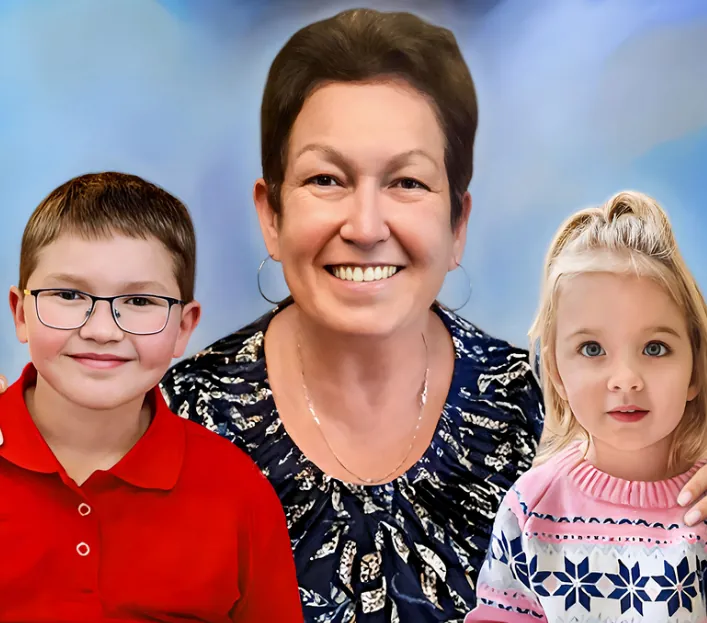 Photo resizing services for a smiling woman with a boy in a red shirt and a girl in a pink sweater.