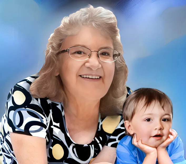 Smiling elderly woman in glasses posing with a toddler against a soft blue background.